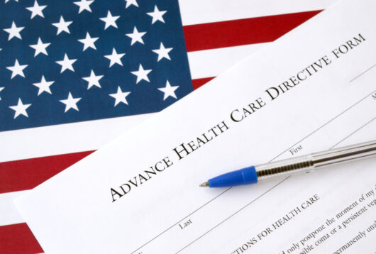 advance health care directive blank form and blue pen on united states flag