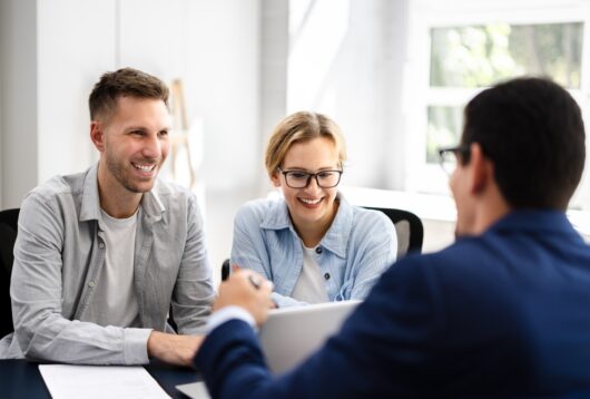 Young Couple Is Meeting With A Financial Planner To Discuss Their Future Investments And Family Finances In An Office.